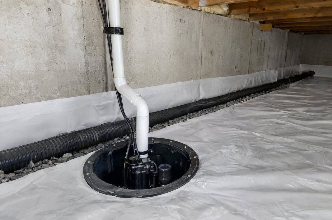 Interior perimeter drain and sump pump installed in a crawl space